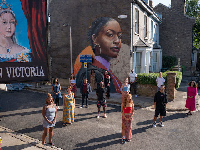 Dreph with the EastEnders cast and crew in front of his mural