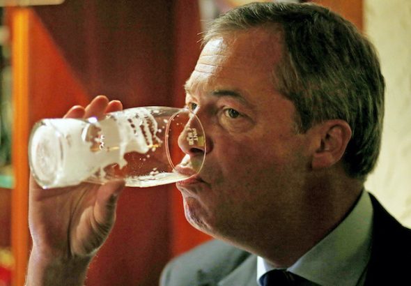 Nigel Farage drinks a pint at the Gardeners Arms in Heywood on October 7, 2014