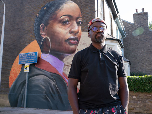 Artist Dreph with his mural on the EastEnders set