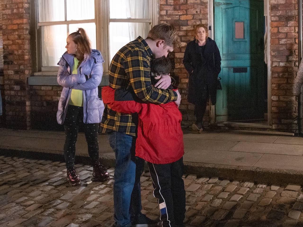 Chesney hugs Joseph as Gemma and Bernie watch on Coronation Street on February 28, 2022