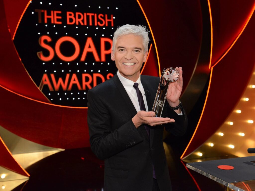 Phillip Schofield holding a British Soap Awards trophy