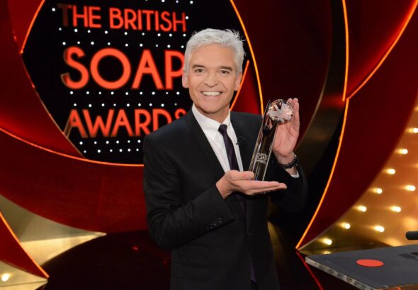 Phillip Schofield holding a British Soap Awards trophy